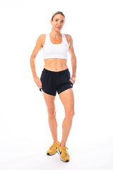Model wearing black Swish Shorts and white sports bra. Loose run shorts with a breathable mesh liner.