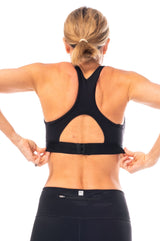 Back view of model wearing the black all sport support high impact bra with jacquard band and adjustable back clasp.