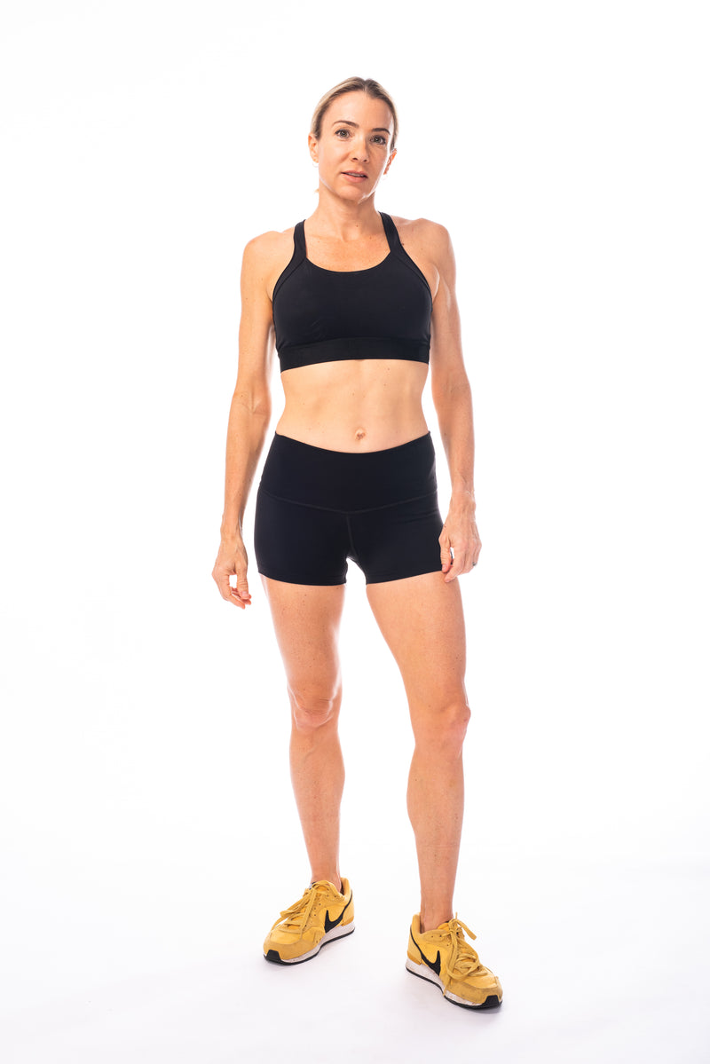 Model wearing all sport support high impact bra with matching black running shorts.