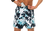 Model placing phone in back pocket of Noosa Run Short. Blue lined running shorts with pockets