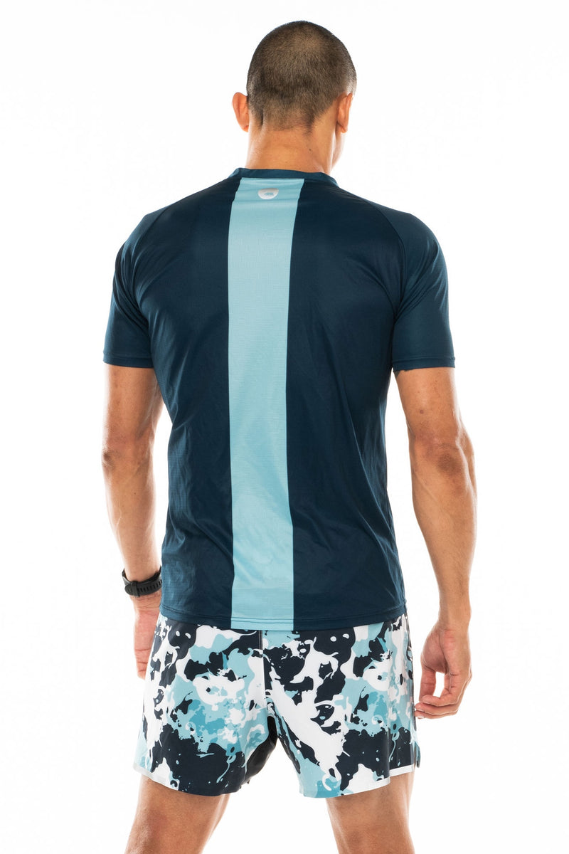 Back view men's blue short sleeve workout shirt. Lightweight running shirt with reflective logo and vertical light blue stripe.
