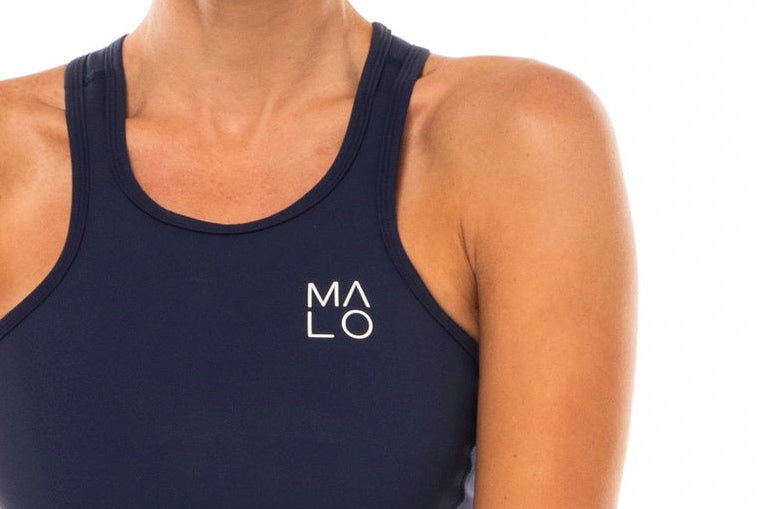 Close view women's Core Crop. Navy crop top with white 'MALO' logo on left chest.