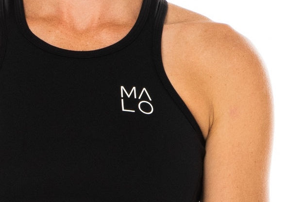Close view women's Core Crop. Black crop top with white 'MALO' logo on left chest.