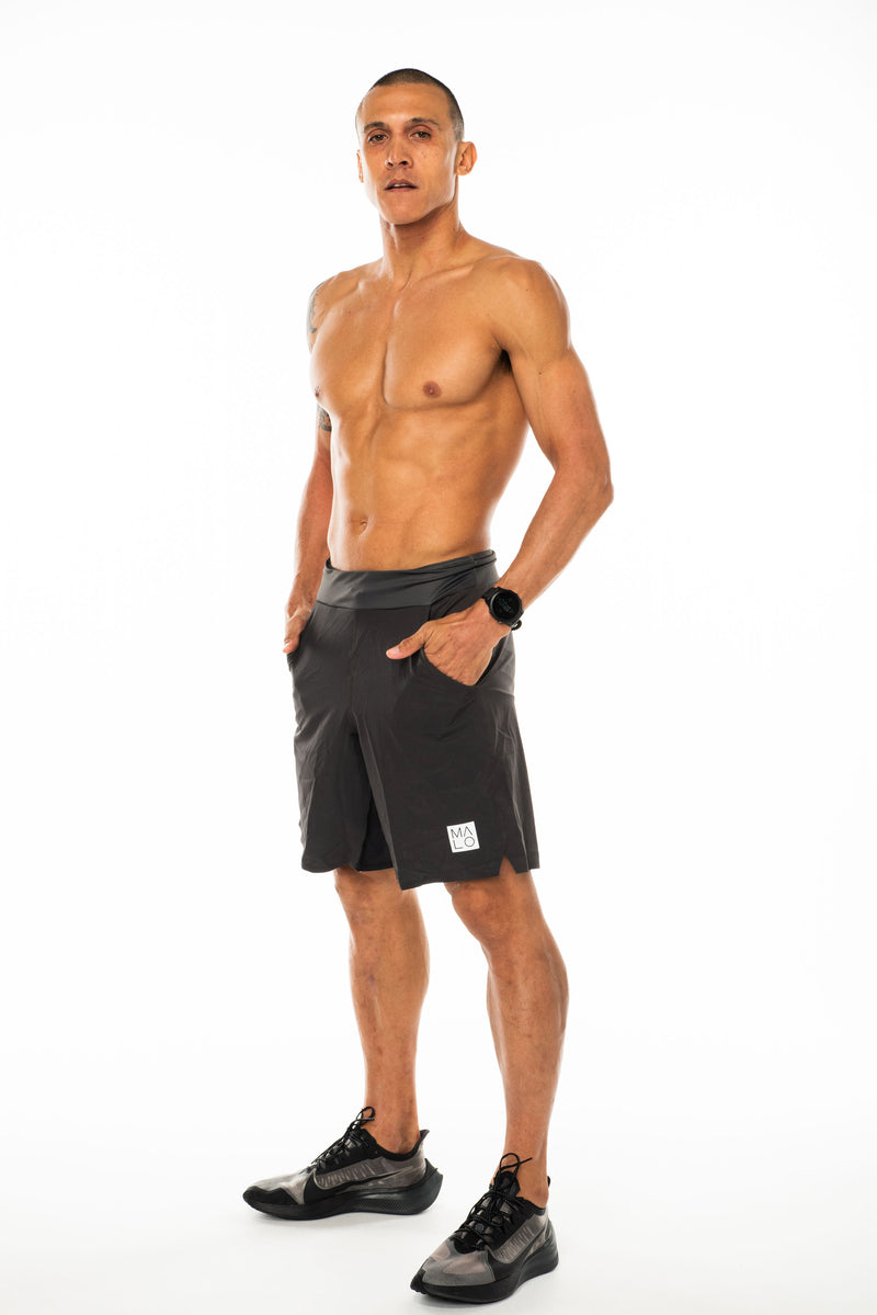 Model wearing Arvo Shorts. Above the knee grey athleisure shorts. Workout shorts with pockets.