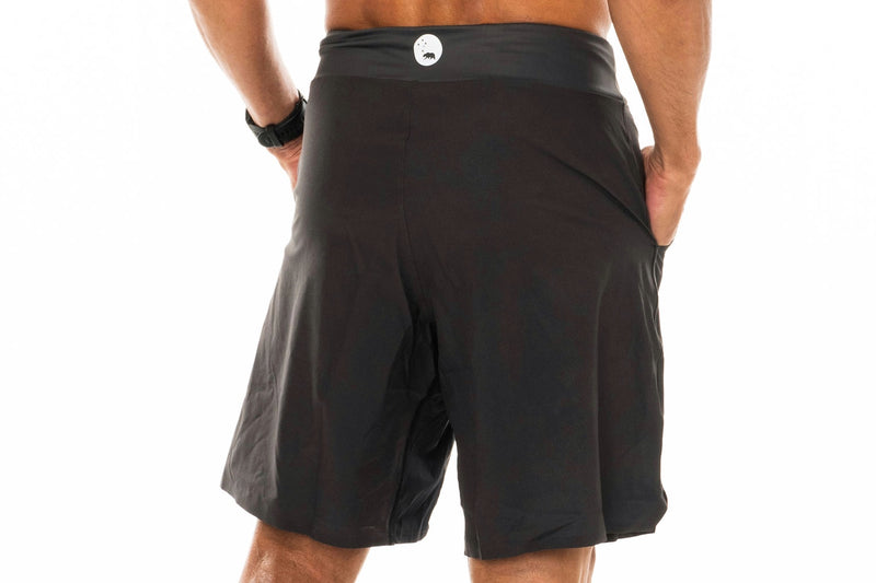 Back view of slate Arvo Shorts. Grey workout shorts with reflective logo on waistline.