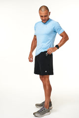 Model wearing black Rep shorts. Men's black athleisure shorts.