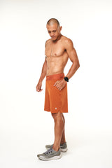 Left view of rust Arvo shorts. Men's gym shorts with comfortable 4-way stretch waistband.