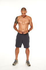 Model tying the drawstring in his charcoal Arvo Shorts. Men's gym shorts with a drawstring for the perfect fit.