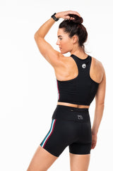 Back view Strata Little Bit Longer athleisure shorts. Women's black workout shorts with back pocket.