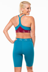 Back view of Pedal Pumpers. Blue Long running shorts with light compression.