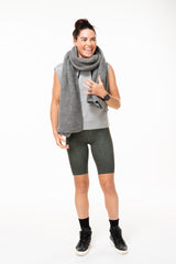 Model wearing Panther Pedal Pumpers with grey tank and scarf. Long green animal print workout shorts with light compression.