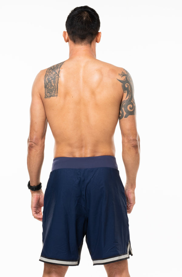Back view of navy/sand/black Arvo Shorts. Navy workout shorts with reflective logo on waistline.