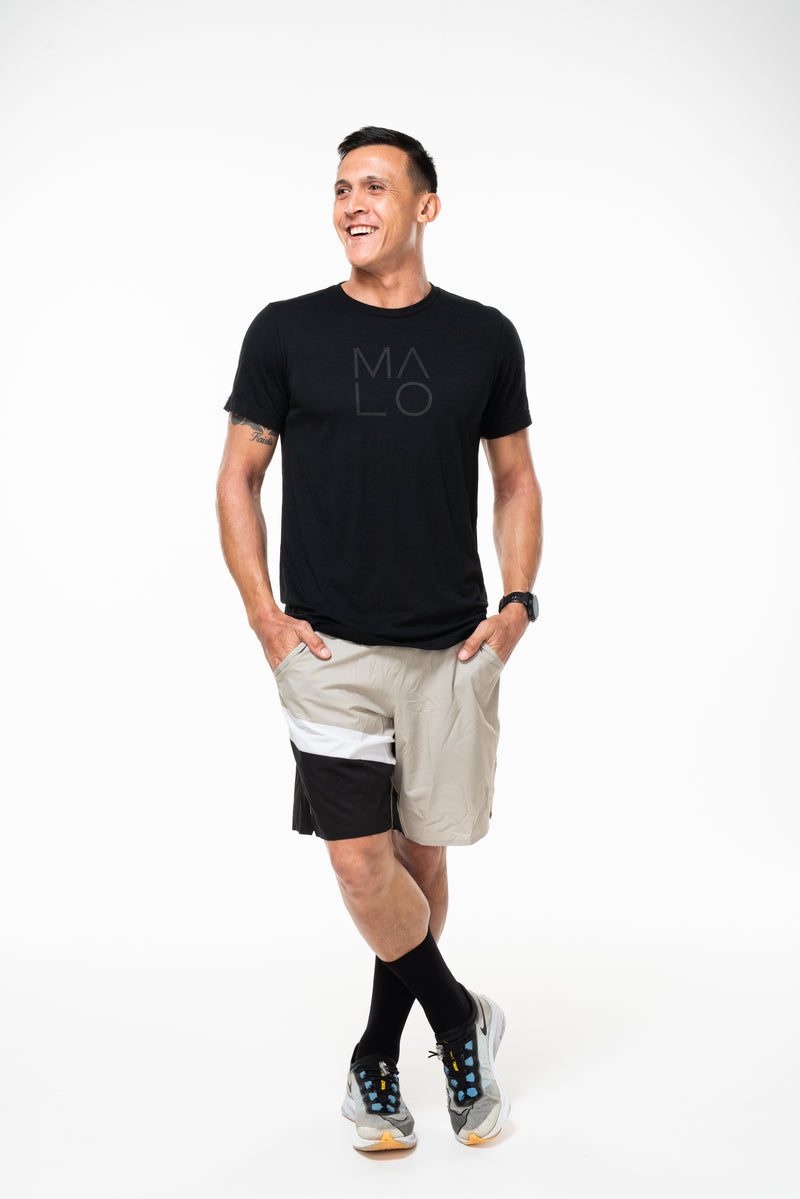 Model wearing Arvo Shorts. Above the knee tan athleisure shorts. Workout shorts with pockets.