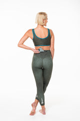 Model placing a phone in Panther 7/8 leggings. Leggings with zipper pocket on waistline.