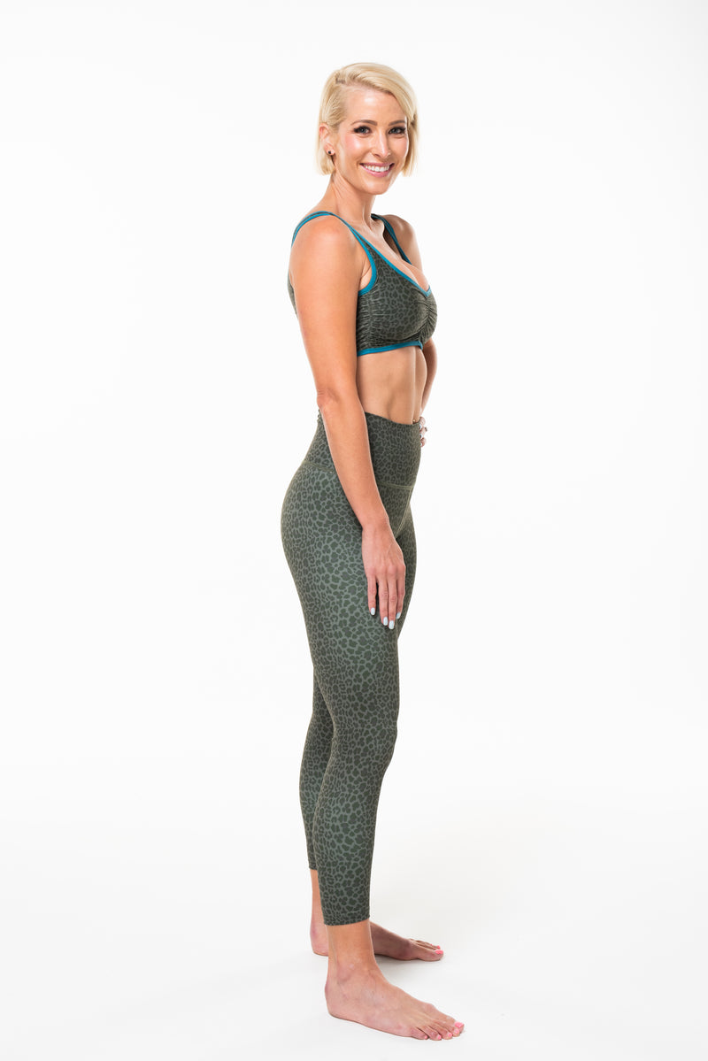 Right view of model wearing Panther 7/8 Tights. Dark green animal print leggings. Breathable and quick-dry tights.