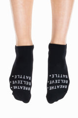 Black ankle socks with Breath. Believe. Battle. logo. Supportive running socks.
