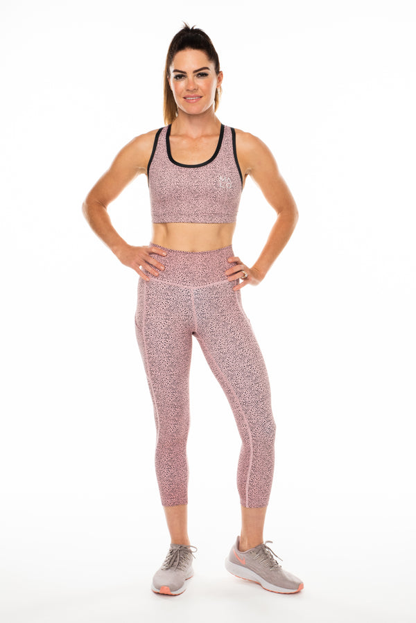 Modeling pink cheetah print 3/4 leggings. Workout leggings falling mid-calf.
