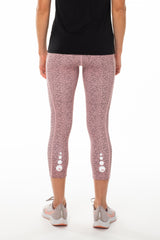 Back view Pacer 3/4 Leggings. Pink animal print leggings with reflective logo. Mid-calf length yoga pants.