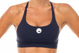 Close view Navy Sunshine Bra. Performance sports bra with reflective logo.