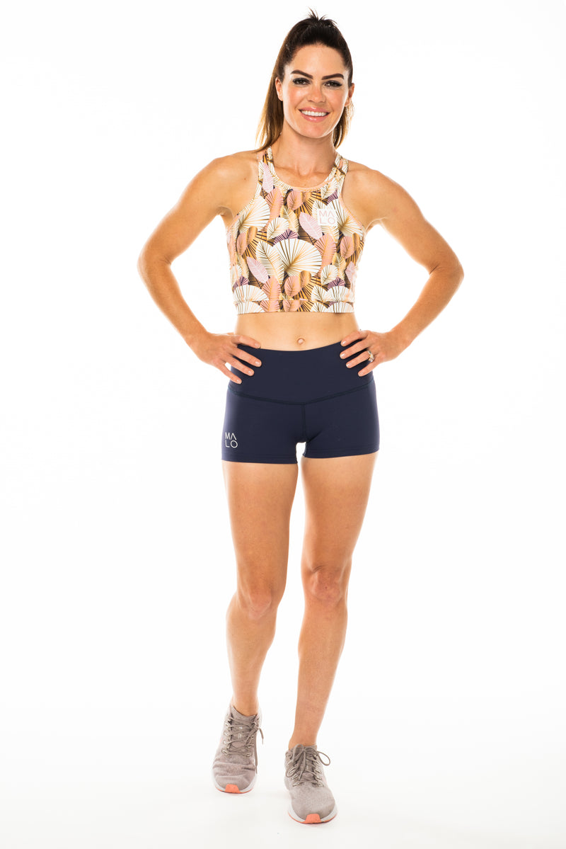 Model wearing Navy PR Shorts. Women's blue athleisure shorts.