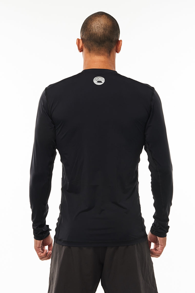 Back view Endure Long Sleeve. Men's black running shirt. Reflective logo for safety.