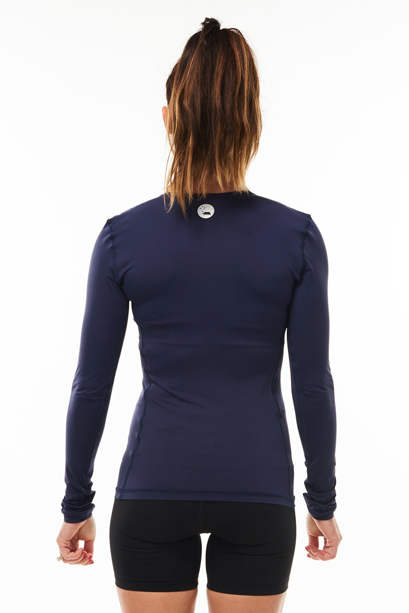 Back view Endure Long Sleeve. Women's navy running shirt. Reflective logo for safety.