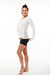 Model showing mesh side panels in long sleeve shirt for ventilation. Black breathable workout shirt.