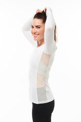 Model lifting arms in Endure Long Sleeve. White lightweight long sleeve running shirt with mesh side panels for ventilation.