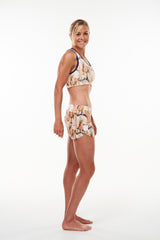 Right view Run The World Shorts. Gold lightweight loose fitting shorts. Flexible workout shorts.