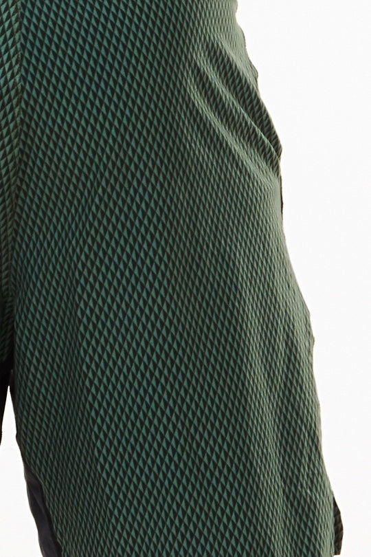 Close view of Sagebrush Reflect Arvo Shorts fabric. Green diamond print design. Workout shorts.