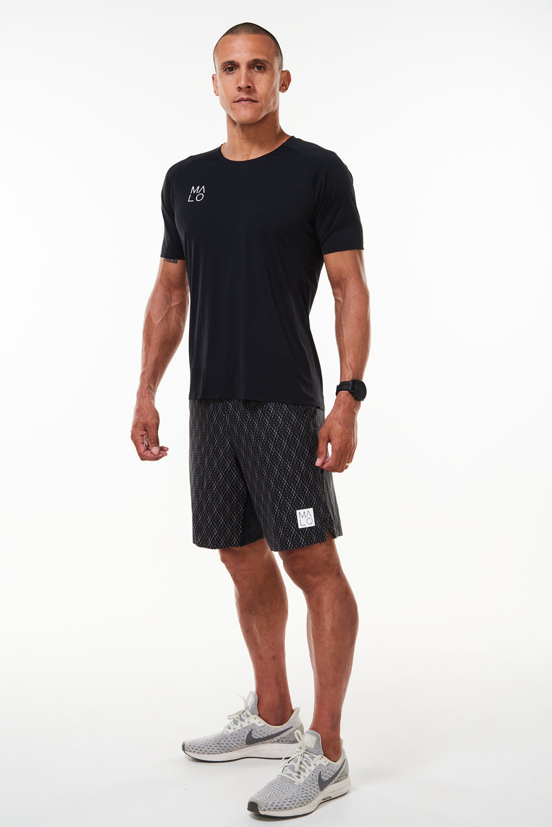 Model wearing Men's Edge Performance Tee. Black short sleeve t-shirt. Black workout shirt.