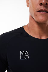 Right chest of Men's Edge Performance Tee. Black workout shirt with white 'MALO' logo.
