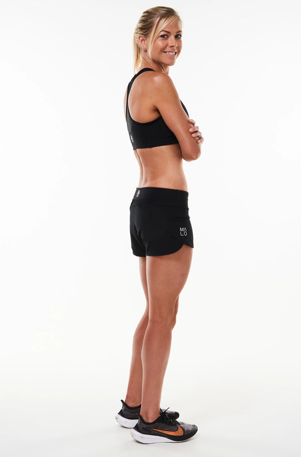 Right view Run The World Shorts. Lightweight loose fitting shorts. Flexible workout shorts.