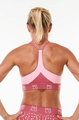 Back view Sunshine Bra. Women's sports bra with pink mesh panels. Performance bra to keep you cool.