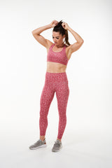 Model wearing Nantucket Bloom Do It Now Bra with matching leggings. Pink athleisure sports bra with daisy print.