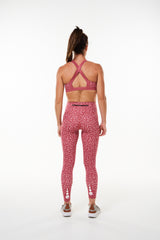 Back view Pacer 7/8 Leggings. Pink leggings with reflective logo. Long length yoga pants.
